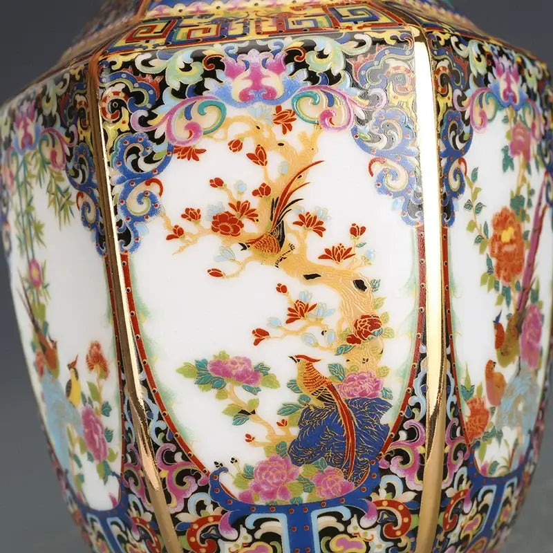 Antique porcelain vase from the collection with vibrant hand-painted birds and blossoms in rich colors and gilded borders