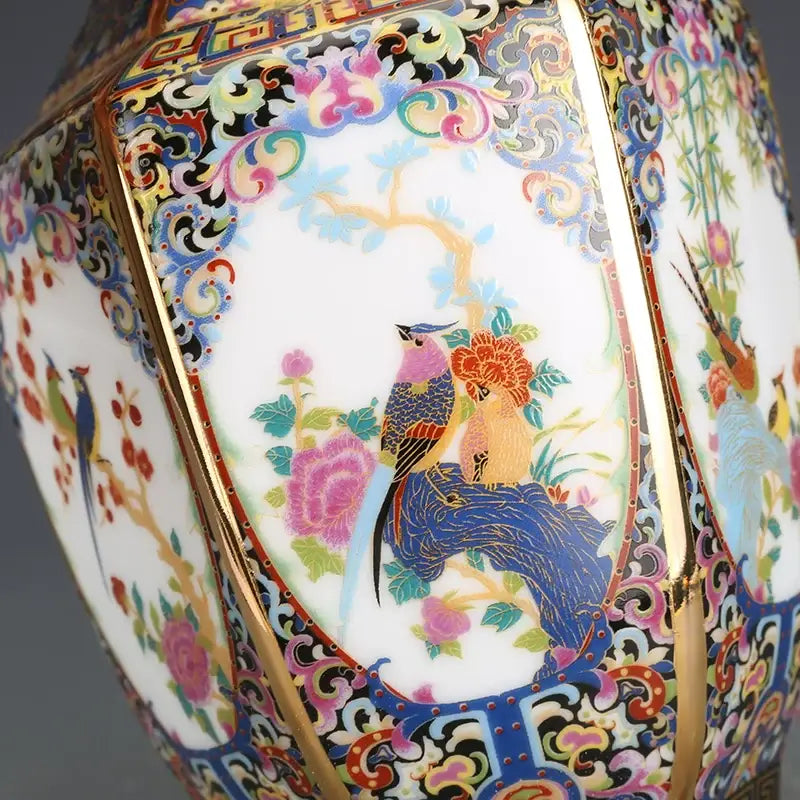 A vibrant hand-painted porcelain vase with intricate floral and bird motifs in pink blue gold and green from a porcelain vase collection