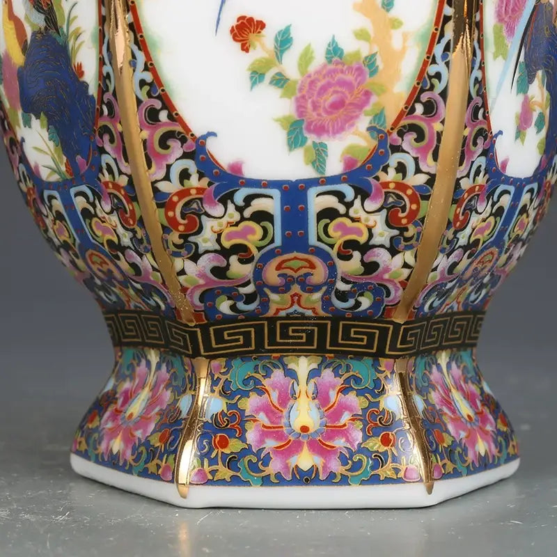 A vibrant antique porcelain vase with gold accents and pink blue green floral motifs in a porcelain vase collection