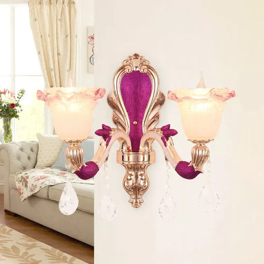 Elegant antique purple and gold double head mount light fixture with pink frosted glass shades and crystal droplets for bedroom