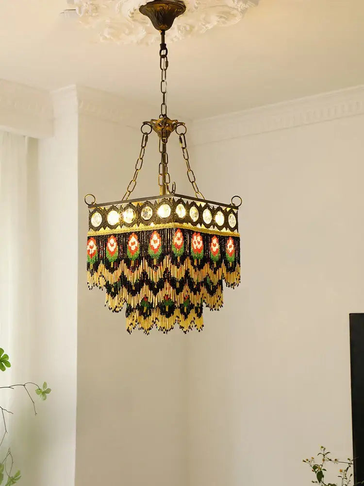 An ornate brass pendant lights chandelier with black rose tassel and intricate gold beaded fringe for living room decorbites black rose