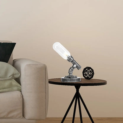 Lámpara de escritorio industrial plateada antigua con pantalla de cristal transparente/ámbar y brazo curvo