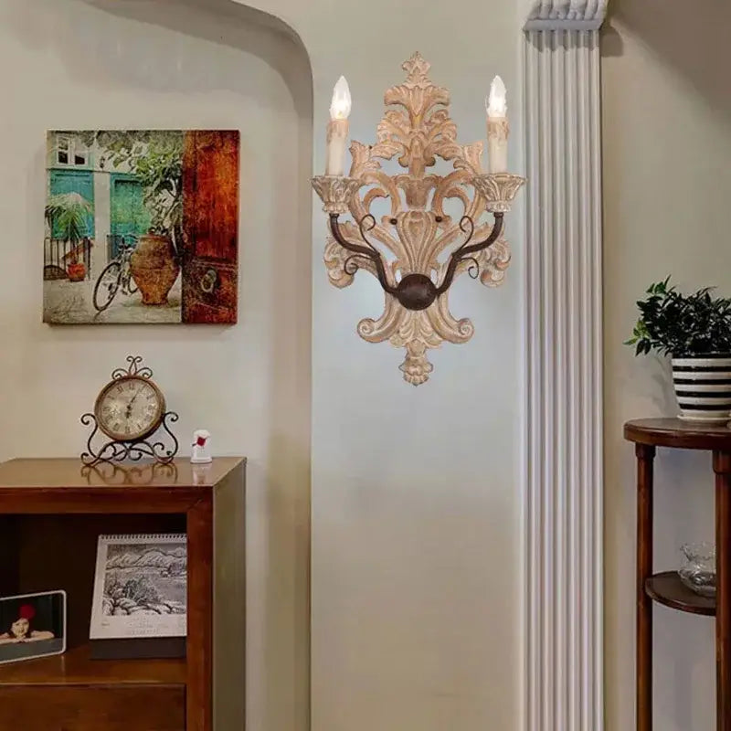 Antique solid wood wall lamp with cream ornate metalwork and three candle-like bulbs for elegant decorbites decor