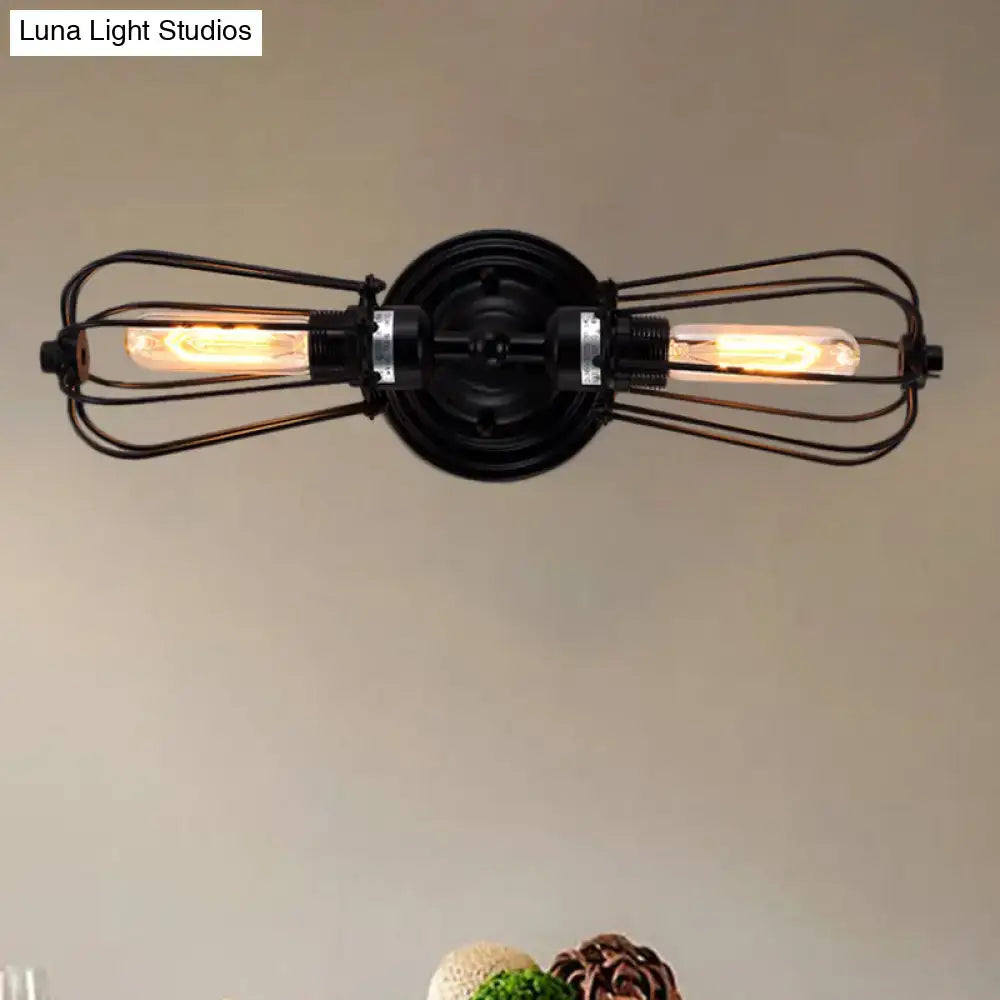 Antique style black bronze sconce light featuring industrial wrought iron with two exposed filament bulbs for dining room