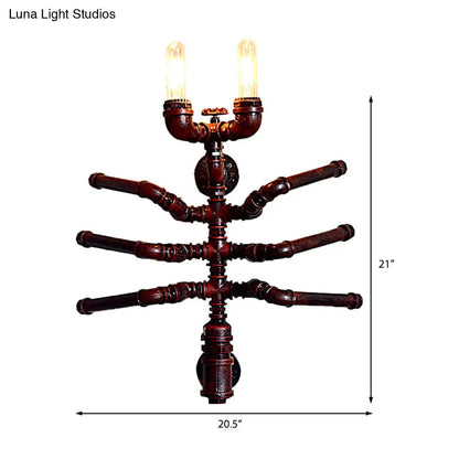 Aplique de pared estilo antiguo con forma de araña, dos bombillas y diseño rústico de tubería.