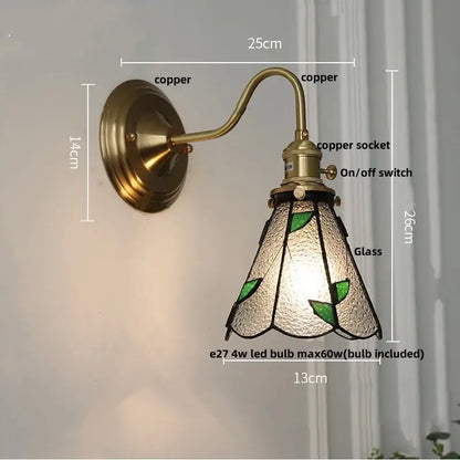 Antique teal glass and brass wall light fixture with vintage copper sconce and textured shade featuring green leaf motifs