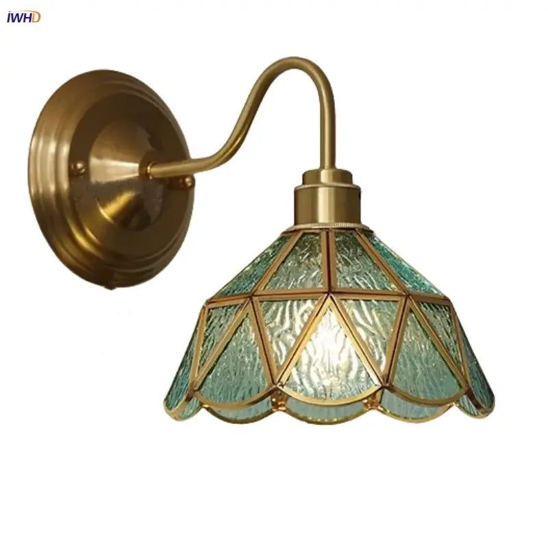 Antique teal glass and brass wall light fixture with textured geometric shade for bedroom sconce lighting