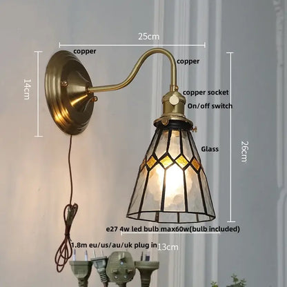 Antique teal glass and brass wall light fixture with copper sconce and stained glass shade in amber and clear geometric patterns