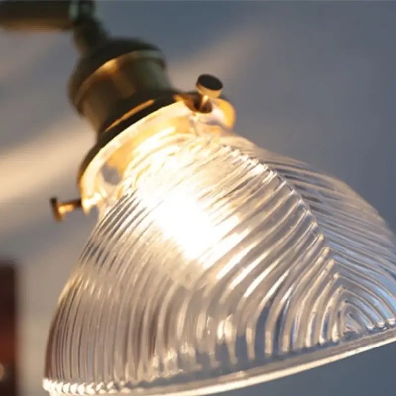 Antique walnut and brass wall light featuring a clear ribbed glass lampshade by decorbites clear glass