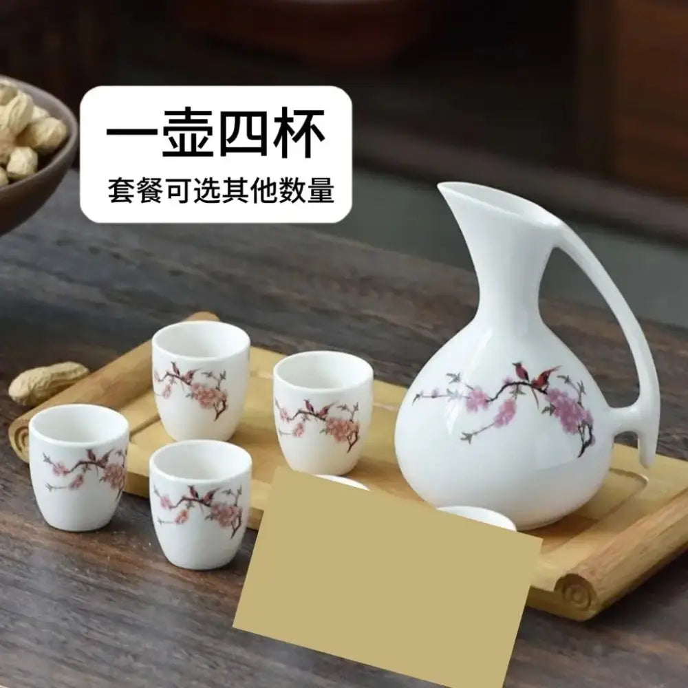 Antique white ceramic warming container set with pitcher and four cups featuring cherry blossom and bird motifs