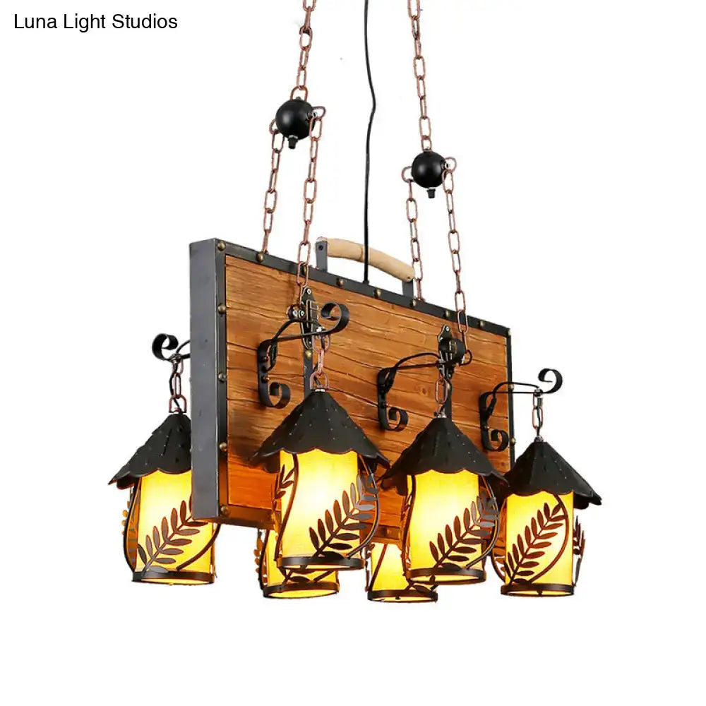 DecorBites antique white dining room chandelier with metal arms and rustic amber glass lanterns featuring leaf cutouts