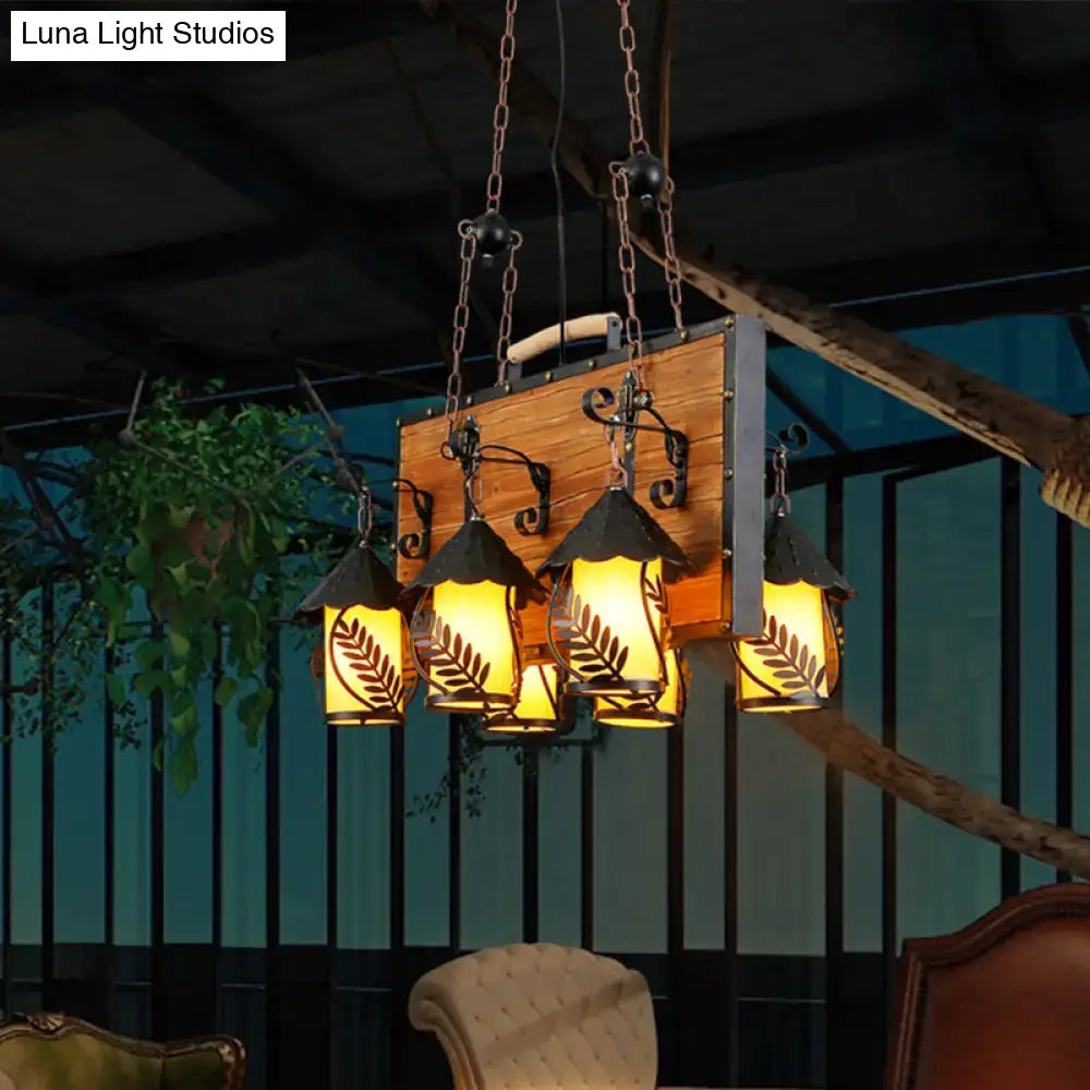 DecorBites™ antique white dining room chandelier with six clear glass lights and black metal leaf-patterned lanterns
