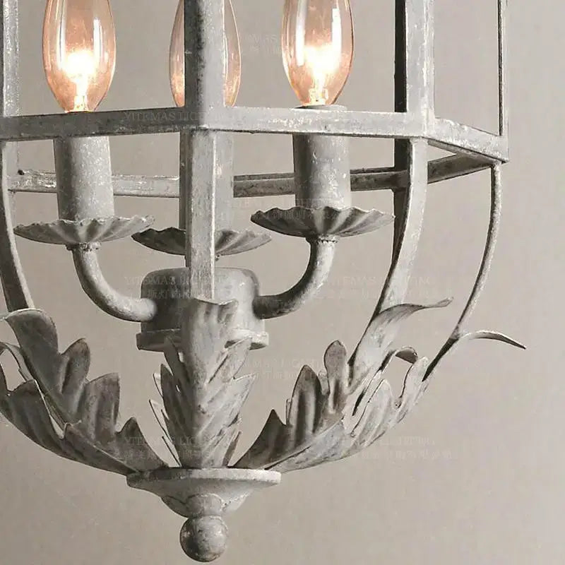 Antique wrought iron elegant candle chandelier in distressed gray metal with ornate leafy detailing for decorbites elegant candle use