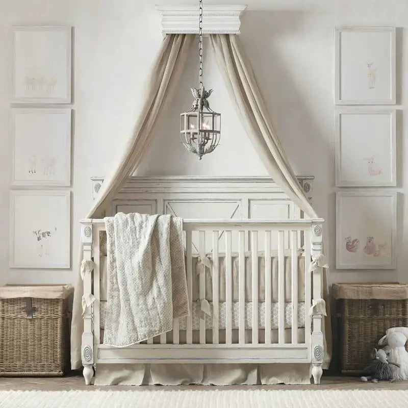 White distressed wood canopy crib with beige fabric drapes under decorbites elegant candle chandelier lights