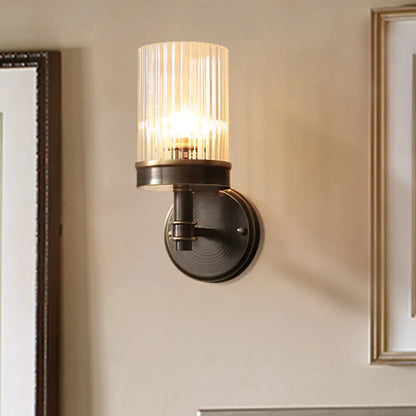 Aplique de pared de cristal negro envejecido con pantalla cilíndrica transparente - Ideal para el dormitorio