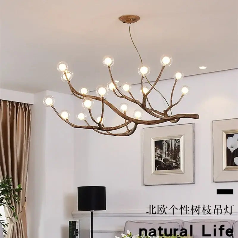 Antler style dark brown pendant light featuring glass bubble led bulbs in a rustic branch design for dining room decorbites