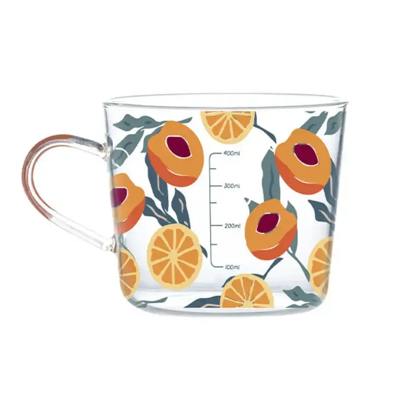 Clear glass 500ml glass mug with apricot and orange pattern in shades of orange and deep red with green leaves