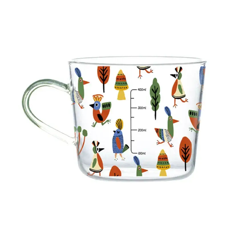 Clear 500ml glass mug decorated with apricot and orange patterned birds and trees for kitchen breakfast use