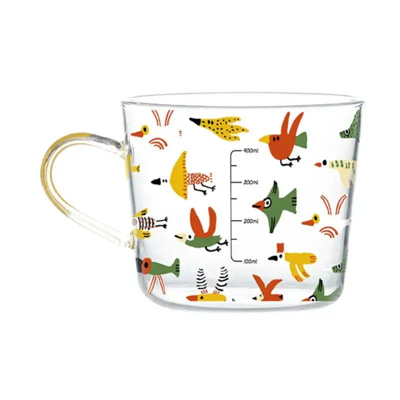 Clear glass 500ml glass mug with yellow handle featuring apricot and orange pattern and colorful cartoon birds