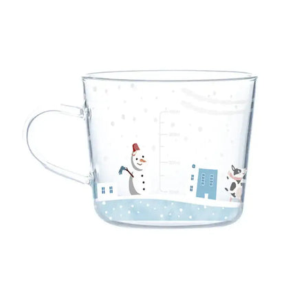 Clear 500ml glass mug with apricot and orange pattern featuring cartoon snowman blue buildings and cow design for breakfast