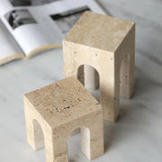 Beige travertine coffee table cabinet mini stools with arched openings and textured surfaces for living room use