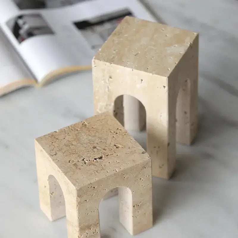 Beige travertine coffee table cabinet mini stools with arched openings and textured surfaces for living room use