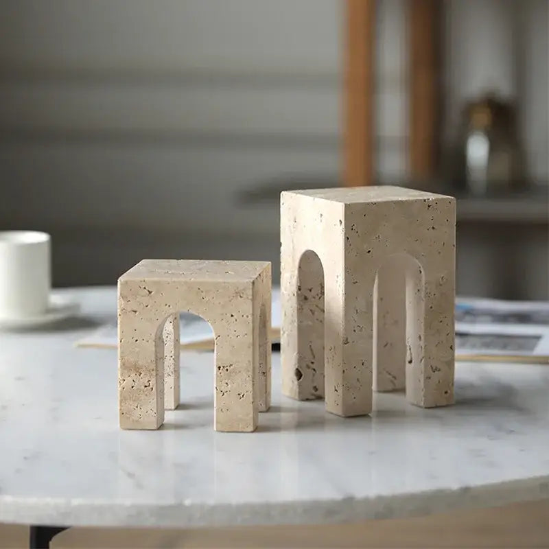 Beige travertine coffee table cabinet bookends with arched cutouts and speckled texture for living room stool use