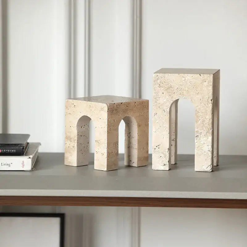 Beige travertine coffee table cabinet bookends with arched cutouts and textured natural stone surface for living room use