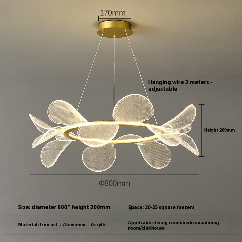 Modern white flower-shaped pendant light with gold accents and adjustable hanging wire.