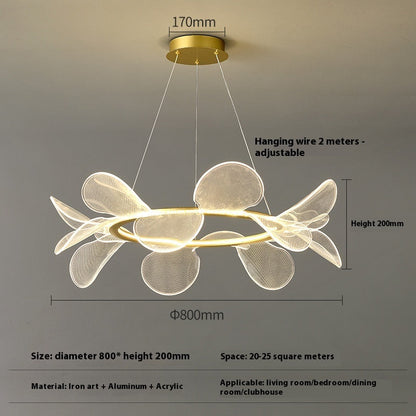 Modern white flower-shaped pendant light with gold accents and adjustable hanging wire.