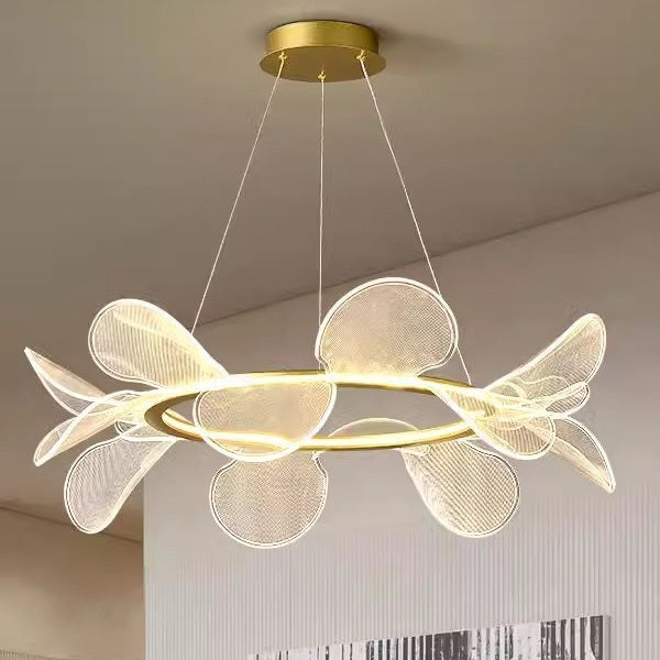 Gold and white modern chandelier with petal-like design, likely from a contemporary lighting brand.