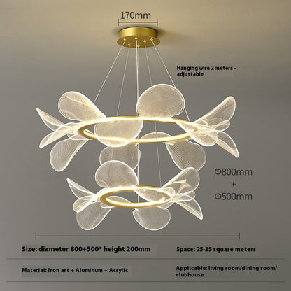 Modern gold-toned chandelier with petal-like acrylic shades and adjustable hanging wire.
