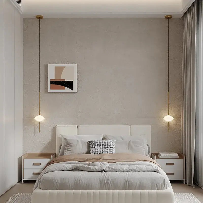 Modern white upholstered bed with tufted headboard and matching nightstands under art deco black and white glass pendant light