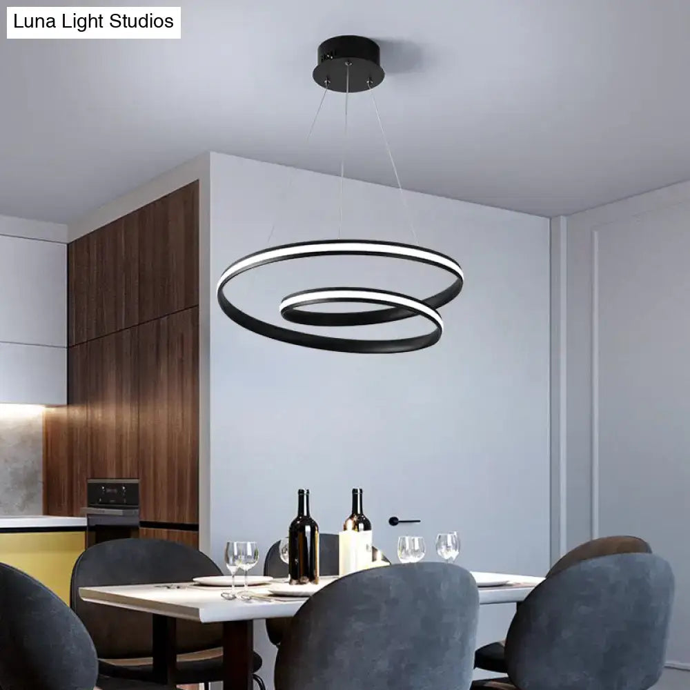 Art deco black and gold led suspension light fixture with modern circular illuminated rings above dining table