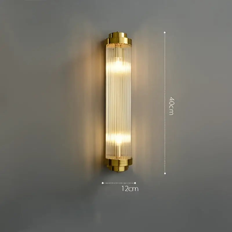 Gold-toned art deco stainless wall sconce with vertical ribbed glass panels by decorbites for bedroom decor
