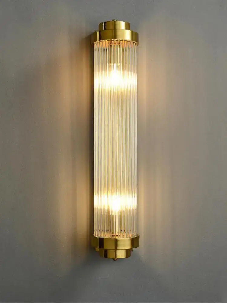 Gold-toned art deco stainless wall sconce with vertical ribbed glass panels for decorbites bedroom lighting decor