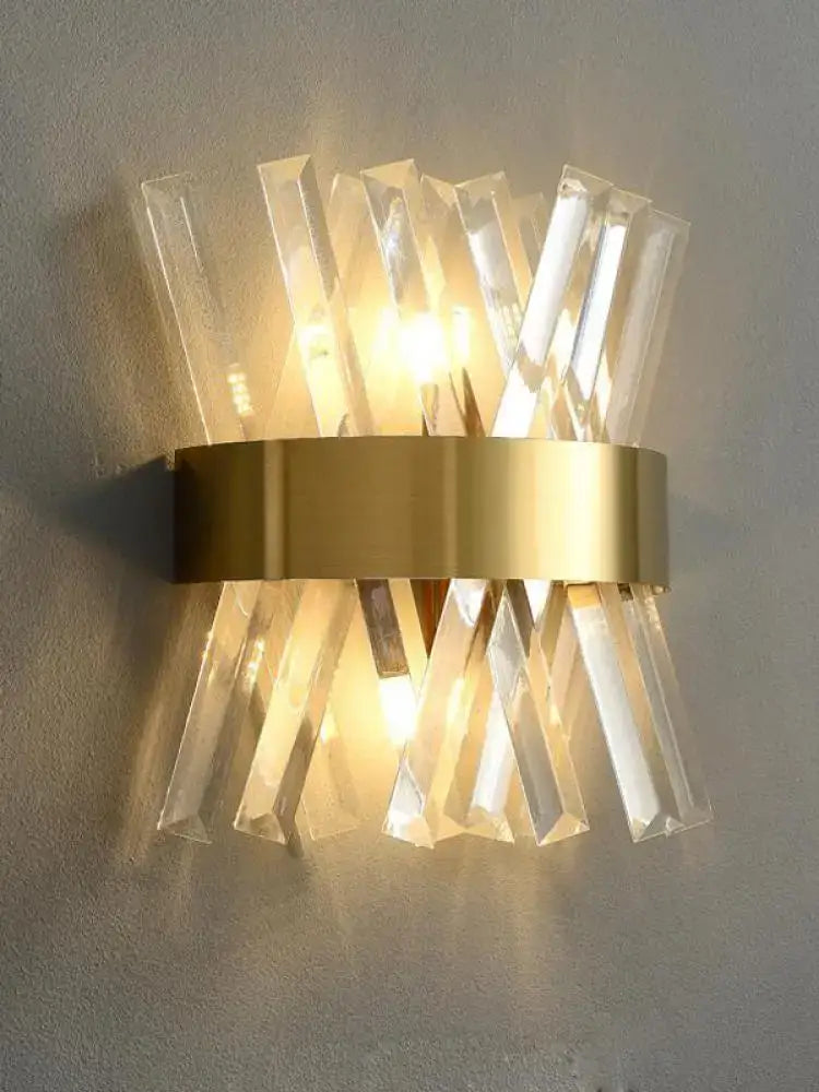 Gold-toned decorbites art deco wall sconce with clear faceted crystal rods and black gold stainless ribbed glass design