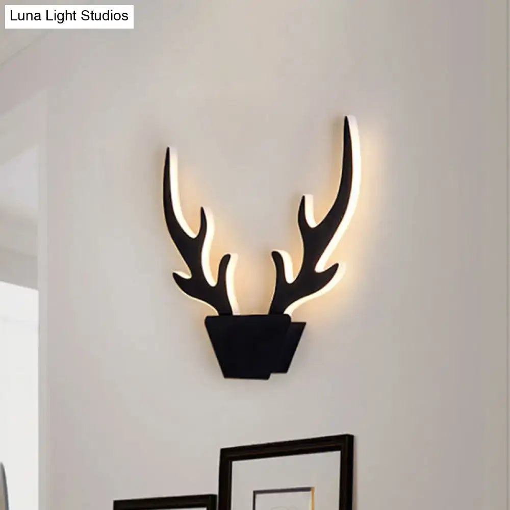 Black art deco light fixture featuring a deer antler shaped bedroom wall sconce with illuminated inner edges and inch fixture design