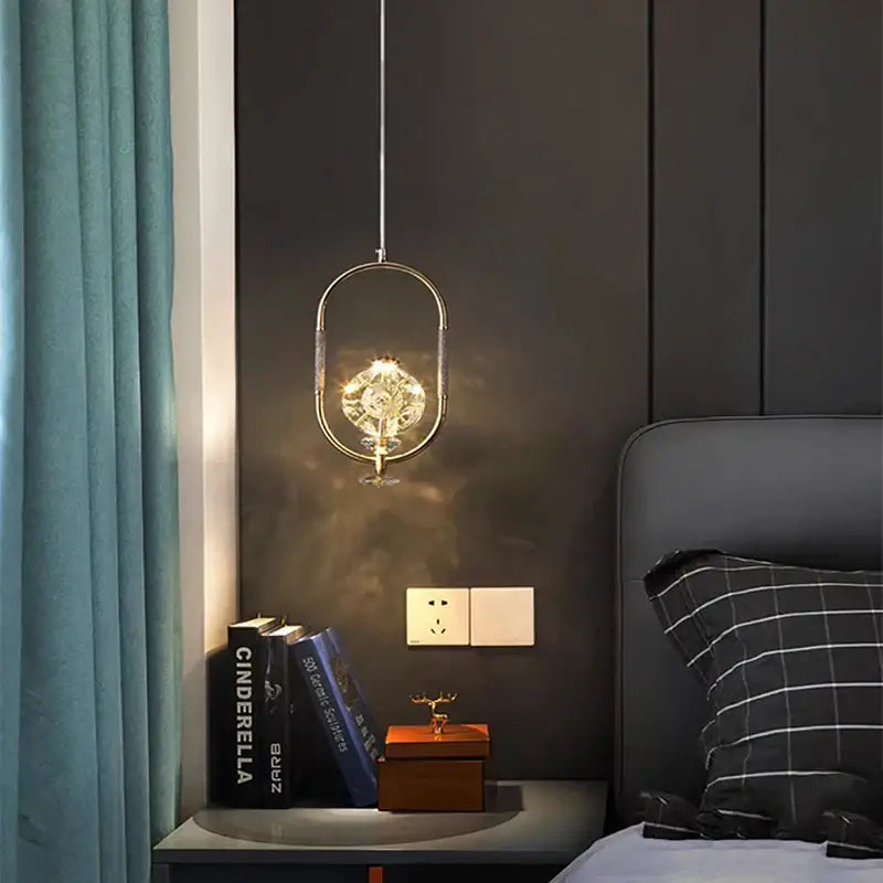 A modern art deco brass crystal led ceiling chandelier with chrome oval frame and illuminated decorbites crystal led centerpiece