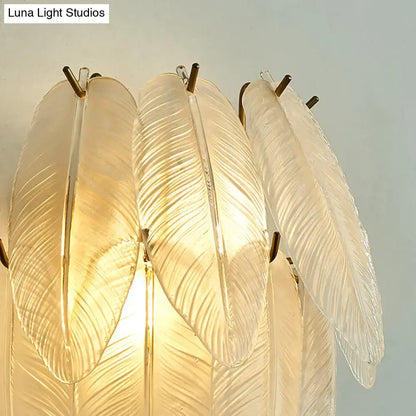 Elegant translucent glass feather chandelier with gold-toned metal accents for dining room leaf sconce lamp with clear glass