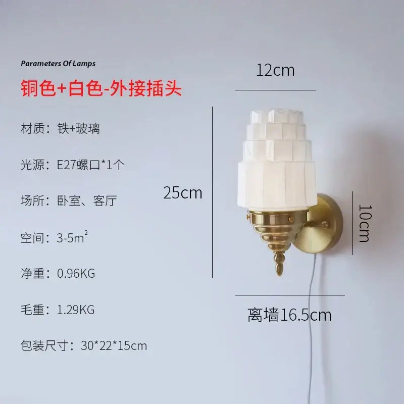 A brass-finished wall lamp with tiered frosted decorbites cream glass led shade for elegant bedroom decor