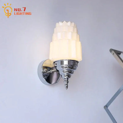 Art deco chrome wall lamp with tiered frosted decorbites cream glass led shade emitting warm bedroom light