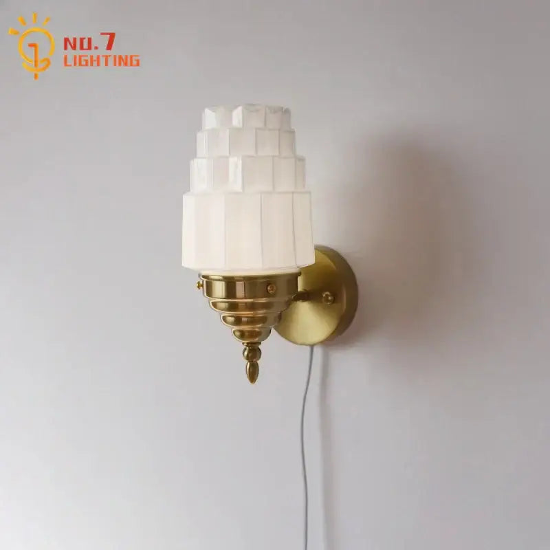 Art deco wall lamp with cream glass led tiered frosted shade and brass-finished metal base for bedroom decorbites cream glass