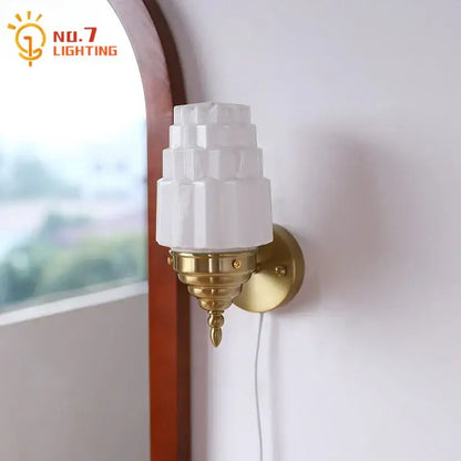 Art deco wall lamp with white tiered decorbites cream glass led shade and brass-finished ornate sconce for bedroom