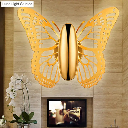 Gold butterfly wall sconce with intricate cutout wings and sleek polished metal body for kids room lighting