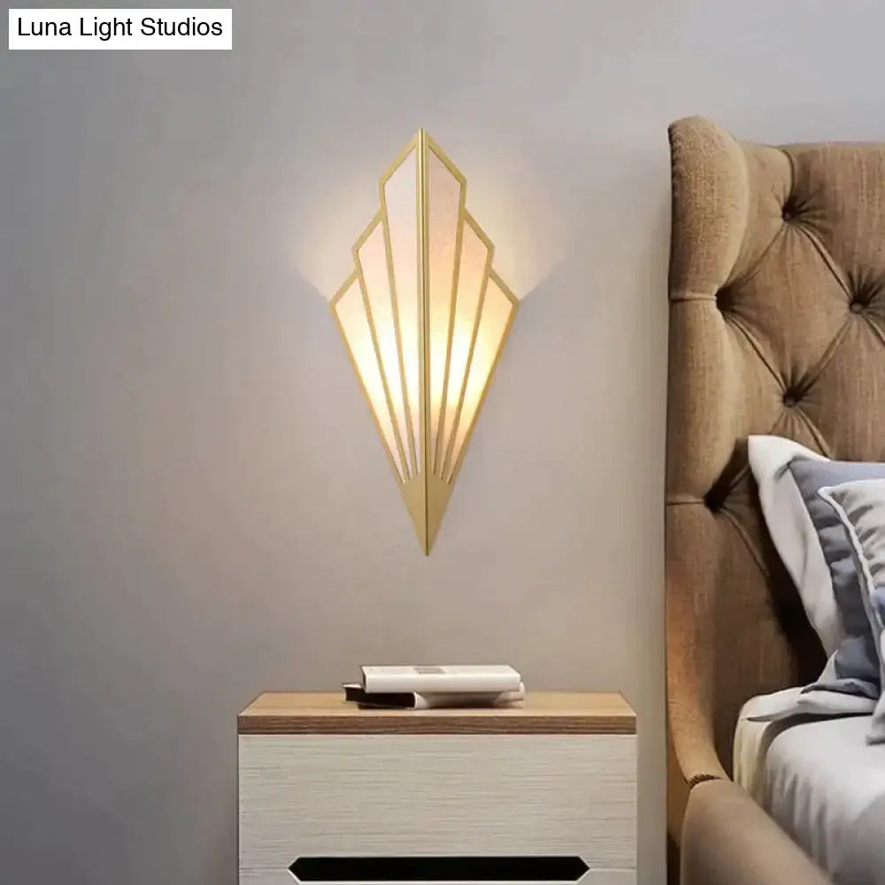 Art deco gold-toned wall light with diamond shape modern fan design and frosted glass panels for bedroom use