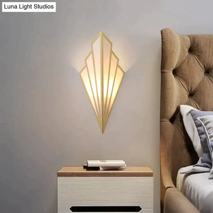 Art deco gold-toned wall light with diamond shape modern fan design and frosted glass panels for bedroom use