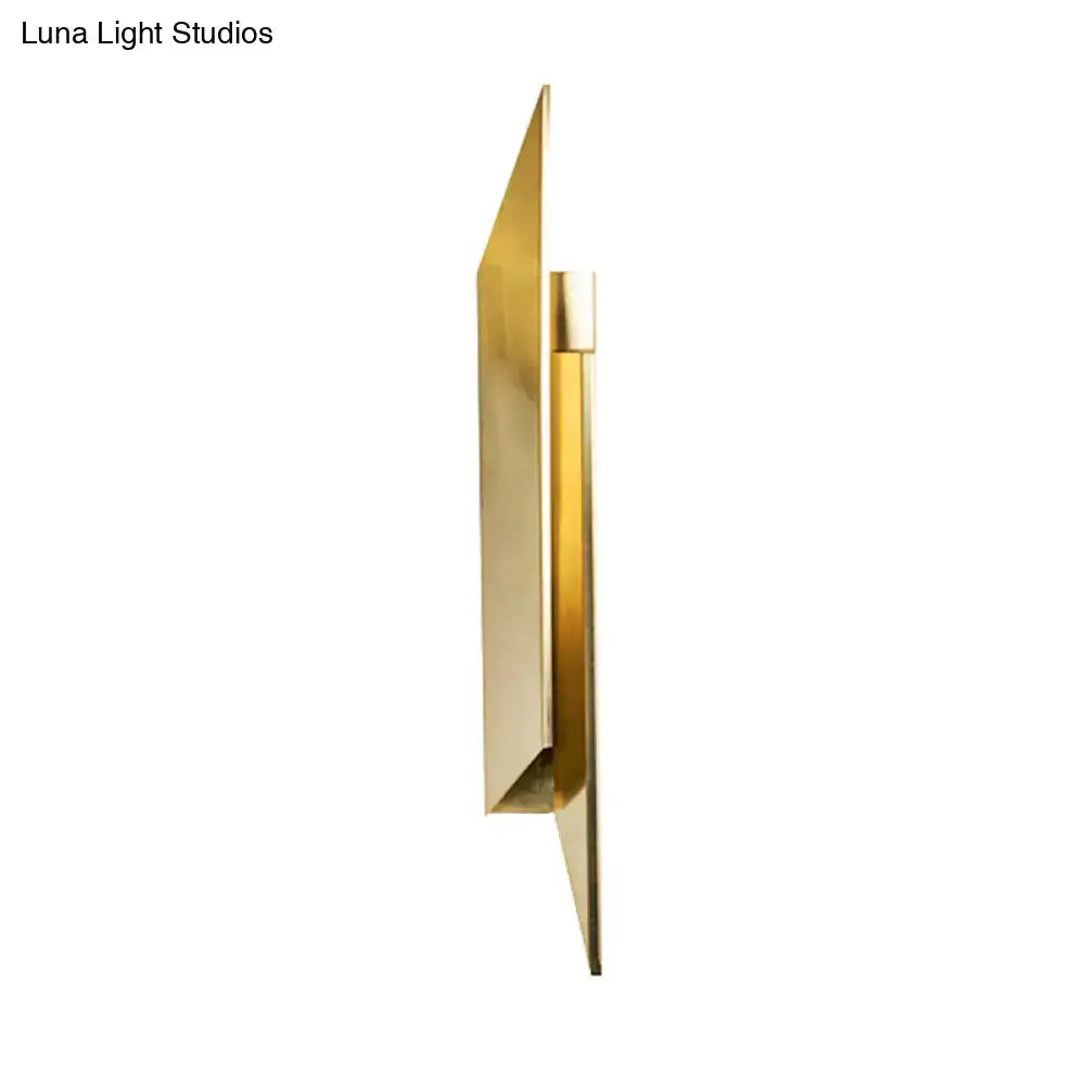 Modern gold-toned metal art deco wall lamp with sleek angular geometric design for bedroom use