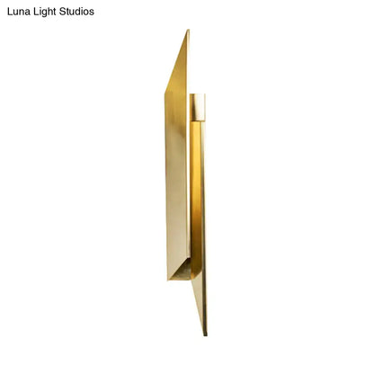 Modern gold-toned metal art deco wall lamp with sleek angular geometric design for bedroom use