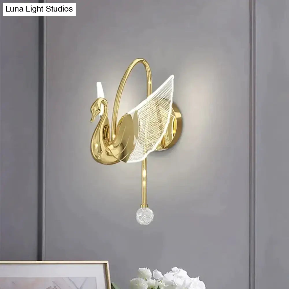 Art deco gold wall lamp shaped like a swan with translucent mesh wing and crystal orb for bedroom bedside wall use